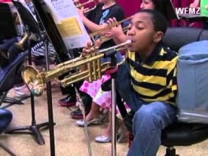 armless boy plays trumpet