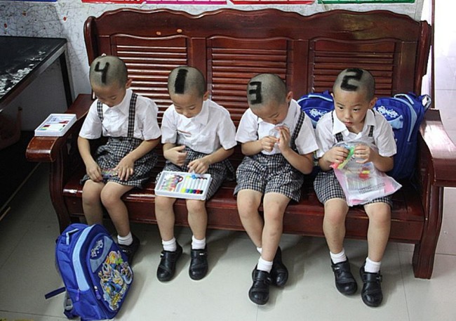 SIX-YEAR-OLD QUADRUPLETS from Shenzhen, China with their hair shaved into numbers before they start go to school for their first time. Their parents decided to mark them with 1, 2, 3, 4 on their heads to make it easier for teachers and classmates to tell them apart. (AMANPOUR. producer Claire Calzonetti says her parents painted her toenail to distinguish her from her twin!)