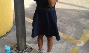 child chained to a pole