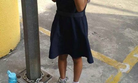 child chained to a pole